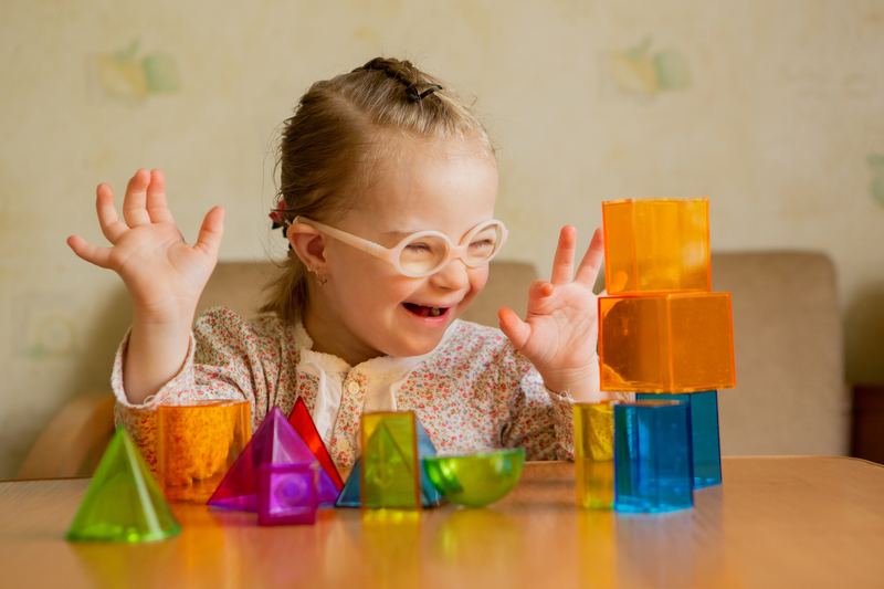 Happy child playing with colourful building blocks