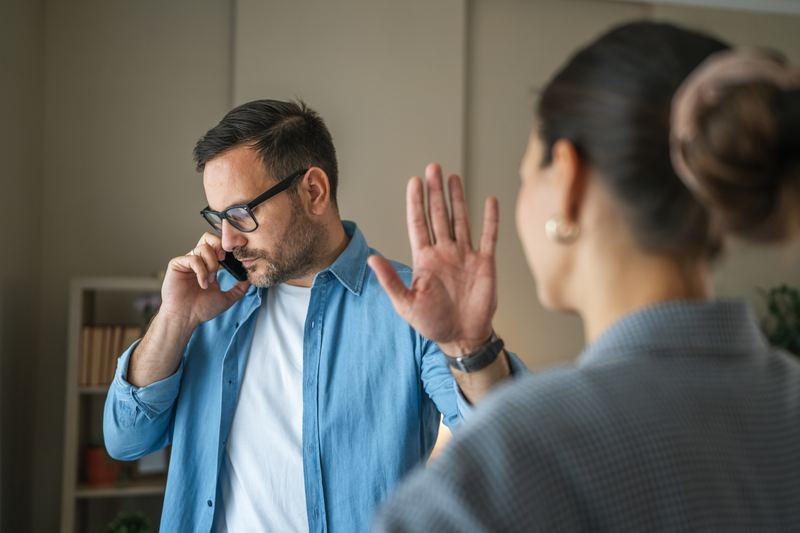 Man holding up hand in a stop gesture
